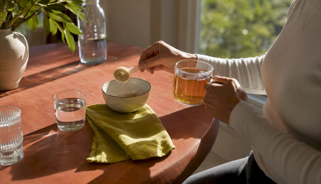 Hands preparing digestive supplements with water