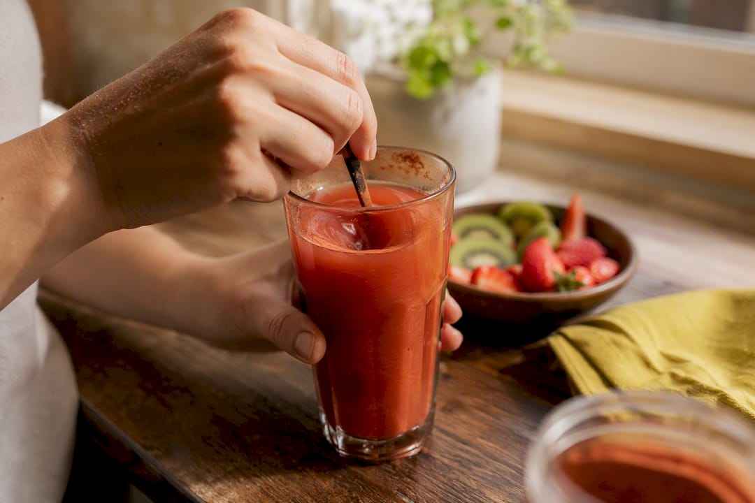 Hands preparing antioxidant supplement with water in morning