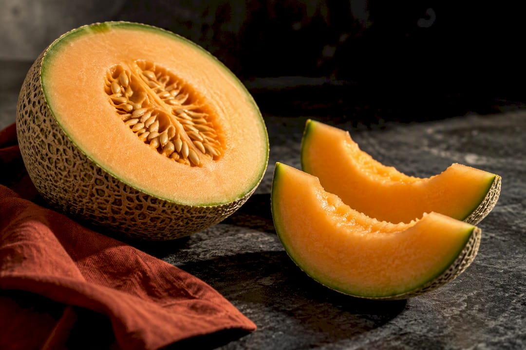 Halved cantaloupe and melon wedges