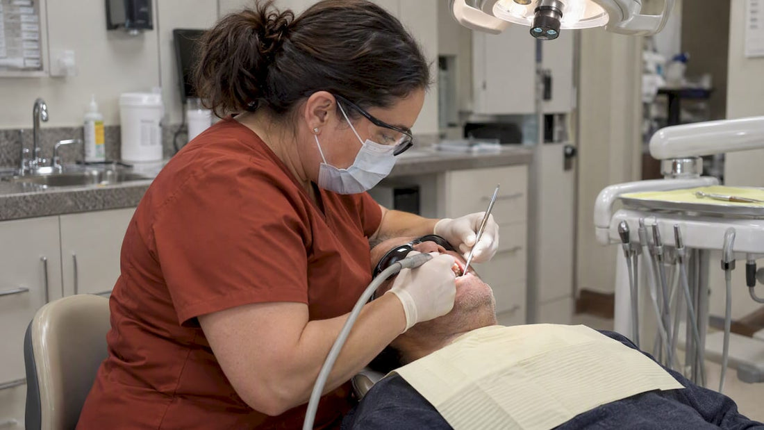 Hygienist cleaning a patient's teeth